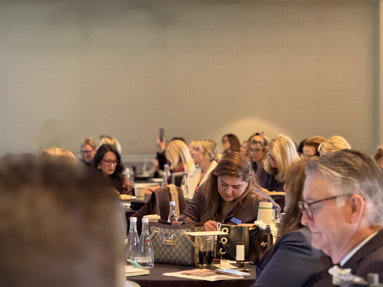 Symposium attendees taking notes